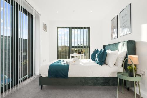 a bedroom with a large bed and a large window at Pluxa Emerald Luxury - Walk to Attractions, Transport Nearby in Birmingham