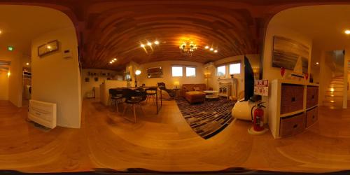 a large room with a wooden ceiling and a living room at Vacanza Resort in Gifu
