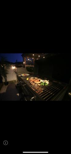 a grill with some food on it at night at Vacanza Resort in Gifu