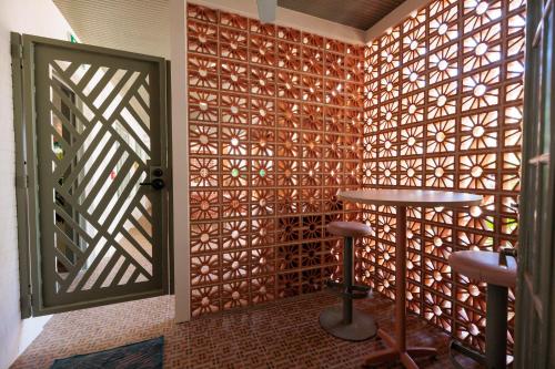 a room with a wooden wall with a door and a stool at The Ryder Hotel in Charleston
