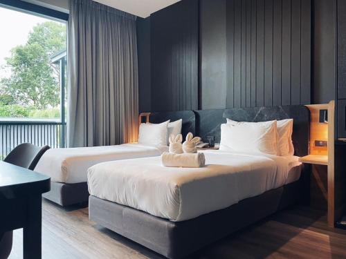 מיטה או מיטות בחדר ב-INN BLOG HOTEL Pakbara