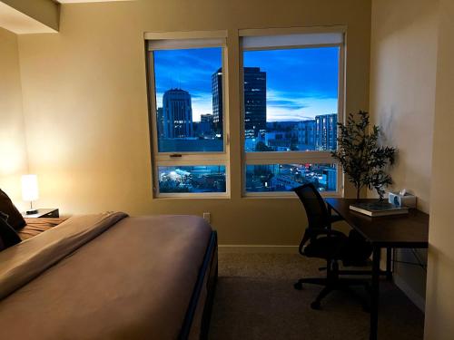 a bedroom with a bed and a desk and a window at Beautiful Home in LA - Parking 10 Min To Cedars in Los Angeles