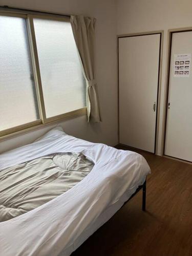 Postel nebo postele na pokoji v ubytování メゾンジョイ久須志#305