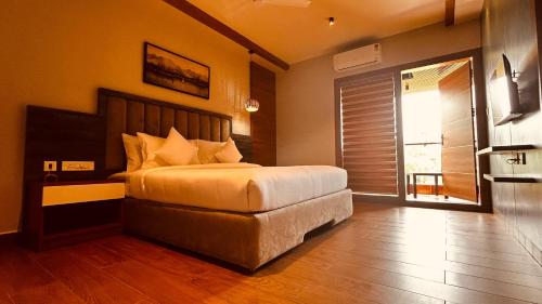 a bedroom with a large bed in a room at CMK HABITAT CENTRE in Ernakulam