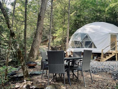 a table and chairs in front of a tent at Moonshine Hollow Dome By Rafting in Cosby