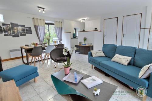 un salon avec un canapé bleu et une table dans l'établissement Fremur, à Pluduno