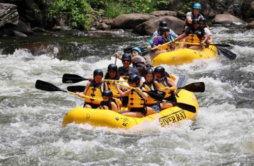 a group of people are rafting in a river at Streamside Shinytiny Airstream In The Smokies in Cosby