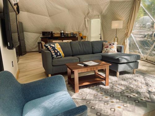 a living room with two couches and a coffee table at Moonshine Hollow Dome By Rafting in Cosby