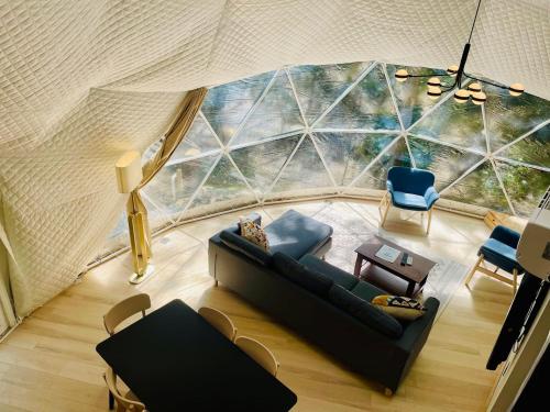an overhead view of a living room with a couch and chairs at Moonshine Hollow Dome By Rafting in Cosby
