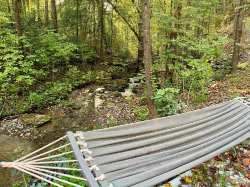 a bench sitting in the middle of a forest at Moonshine Hollow Dome By Rafting in Cosby