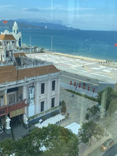 a view of a building next to the ocean at Happy Light Central Nha Trang in Nha Trang