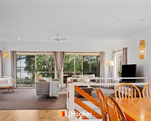 a living room with a couch and a table at The Moorings in Iluka