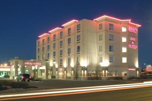 a large white building with lights on top of it at Rosslyn Inn & Suites in Edmonton