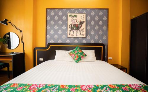 a bedroom with a bed and a picture on the wall at VietHouse Homestay Ha Long in Ha Long