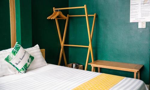 a bedroom with a bed and a green wall at VietHouse Homestay Ha Long in Ha Long