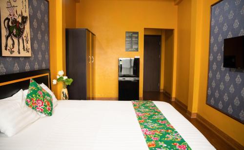 a bedroom with a bed and a refrigerator at VietHouse Homestay Ha Long in Ha Long