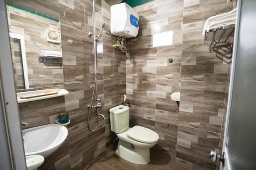 a bathroom with a toilet and a sink at VietHouse Homestay Ha Long in Ha Long