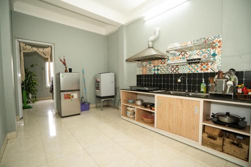 a kitchen with a refrigerator and a counter top at VietHouse Homestay Ha Long in Ha Long