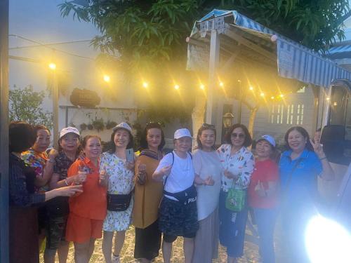 a group of women are posing for a picture at Villa sân vườn Misa in Phan Thiet