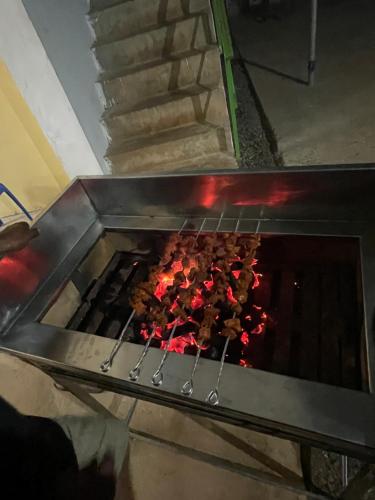 a grill with a bunch of food cooking in it at Best Mist in Idukki