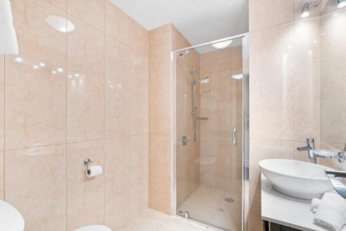 a bathroom with a shower and a sink at THE BEACON - 2 BEDROOM TOWN CENTER APARTMENT 614 in Queenstown
