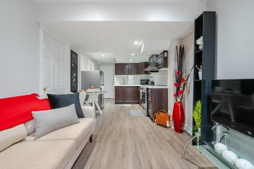 a living room with a couch and a kitchen at Lovely Cozy Apartment in Brampton