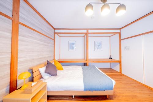 a bedroom with a bed and a desk with a lamp at Powder Chalet Furano - Vacation STAY 27375v in Furano