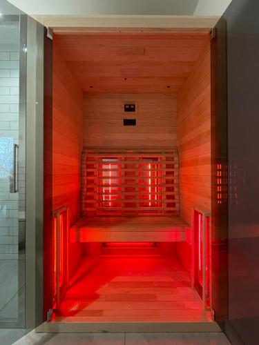 an empty sauna with red lights in a room at Apartament pod Wielką Sową z Sauną Infrared in Pieszyce