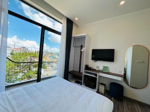 a hotel room with a bed and a large window at Memory Inn - Valley View in Xuan An