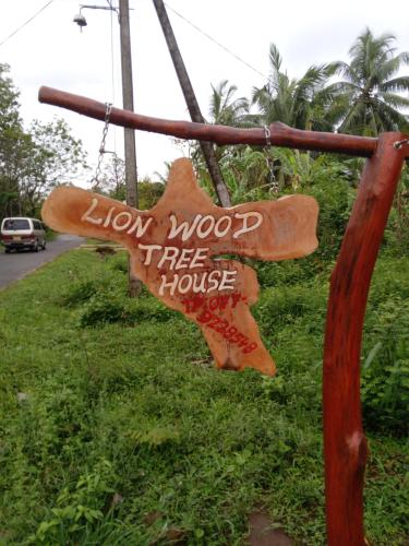 a sign that reads lion two tree house at Lion Wood Treehouse in Talkote