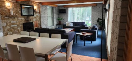a living room with a table and a couch at White Sands Estate in Falmouth