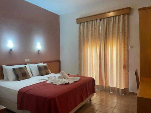 a hotel room with a bed with towels on it at Hotel Stella in Volos