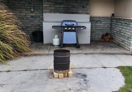 a barbecue grill sitting outside of a building at White Sands Estate in Falmouth