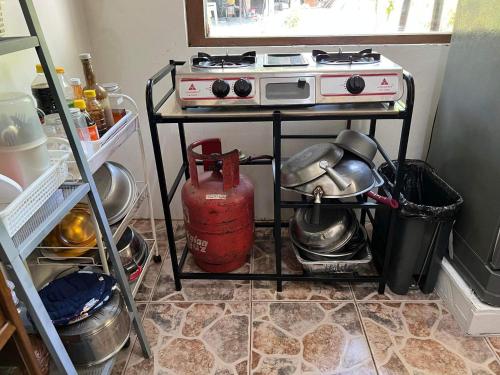 a kitchen with a stove on a cart in a kitchen at SSC Transient House & Staycation - Imus in Imus