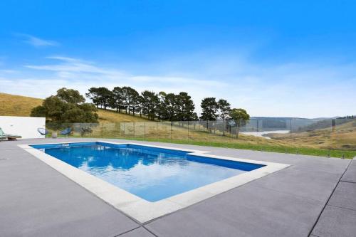 a swimming pool in the middle of a yard at The Lakehaus at Lyell in Bowenfels