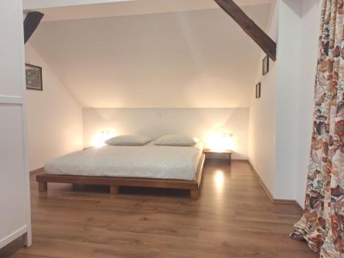 a bedroom with a bed with two pillows on it at Apartma Marija in Metlika