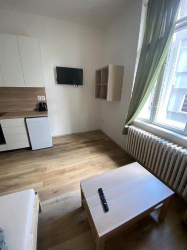 a living room with a couch and a table at Garsoniéra Ostrava City centr, Na Hradbách 118 in Ostrava