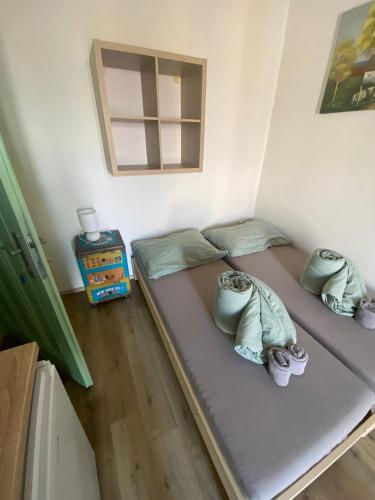 a bedroom with a bed with shoes on it at Garsoniéra Ostrava City centr, Na Hradbách 118 in Ostrava