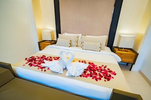 a bedroom with a bed with red flowers on it at La Boutique villas Seminyak Bali in Seminyak