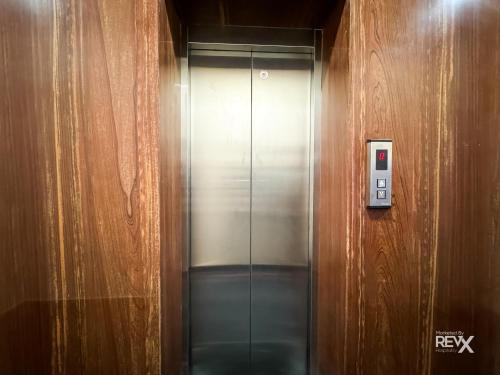 an elevator in a building with a metal door at Guru Sadan A Luxe Stay in Ayodhya