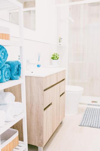 a white bathroom with a sink and a toilet at VV La Niña - Salinetas -Telde in Las Palmas de Gran Canaria
