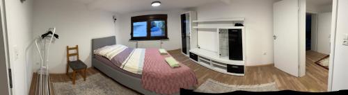 a bedroom with a bed and a tv in it at Das Rosenhaus in Hargesheim in Hargesheim