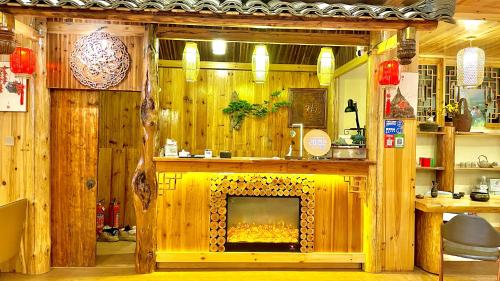 a fireplace in a room with wooden walls at 麦田间民宿 Terrace View Guesthouse in Longsheng