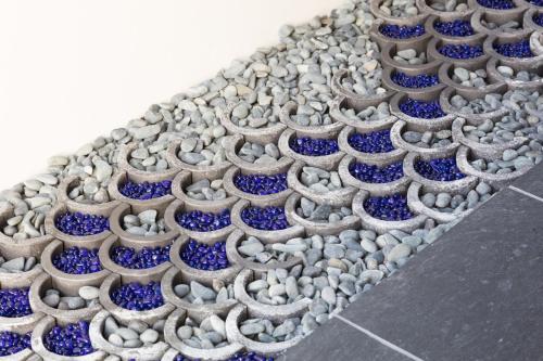 a row of blue and white vases on a sidewalk at 藤華/京都 in Kyoto