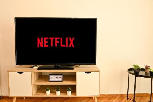 a television on a tv stand with the netflix sign on it at Thessaloniki Center Aristotelous Apartment in Thessaloniki