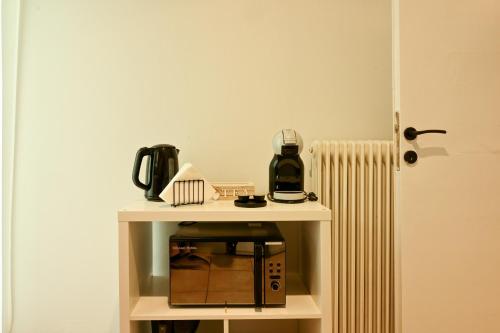 a small white table with a coffee maker on it at Thessaloniki Center Aristotelous Apartment in Thessaloniki