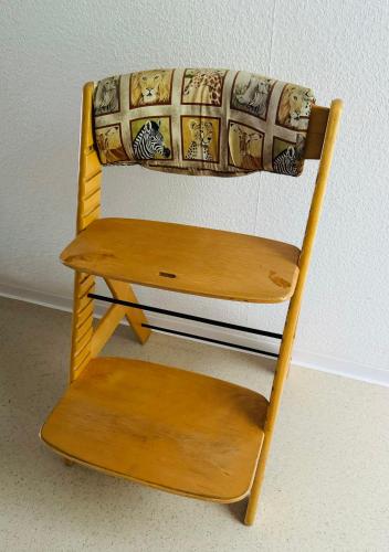 a wooden chair with a blanket on top of it at Enjoy Hiking in Aufseß
