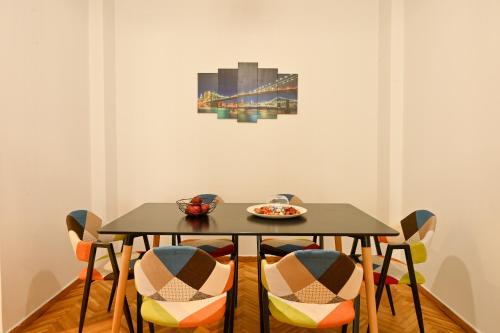 a table with chairs and a plate of food on it at Thessaloniki Center Aristotelous Apartment in Thessaloniki