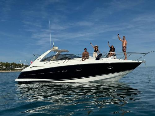 a group of people on a boat in the water at Marbella Beach Front Edificio Mayoral Centro Ciudad y Primera Línea Playa Muy Amplio y Espacioso in Marbella
