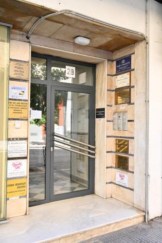 an entrance to a building with a glass door at Thessaloniki Center Aristotelous Apartment in Thessaloniki